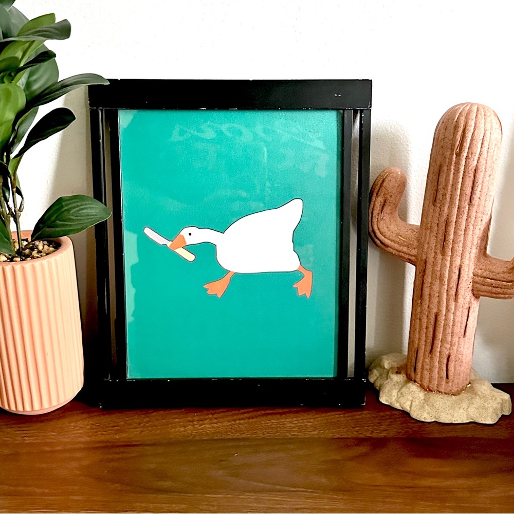 Silly Goose with a Butter Knife Green Canvas Print Black Framed Quirky Wall Art
